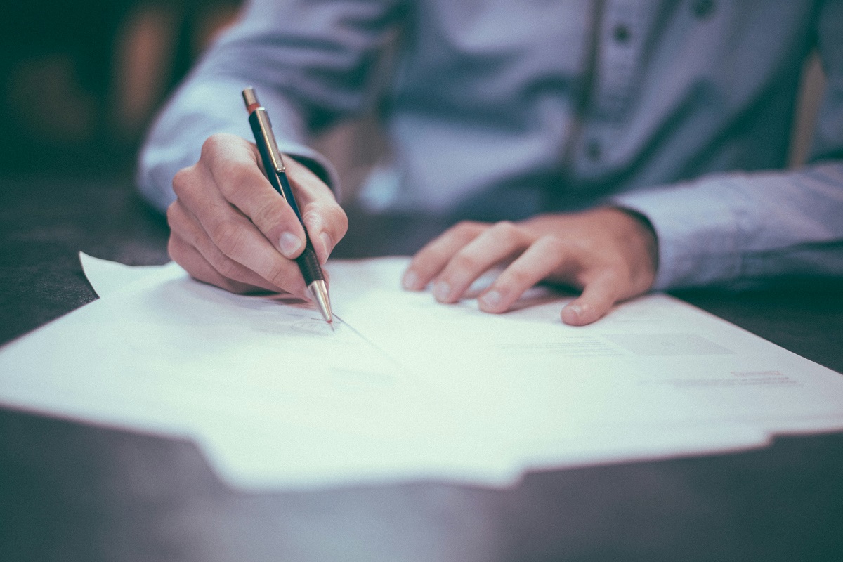 close-up of a man writing a will